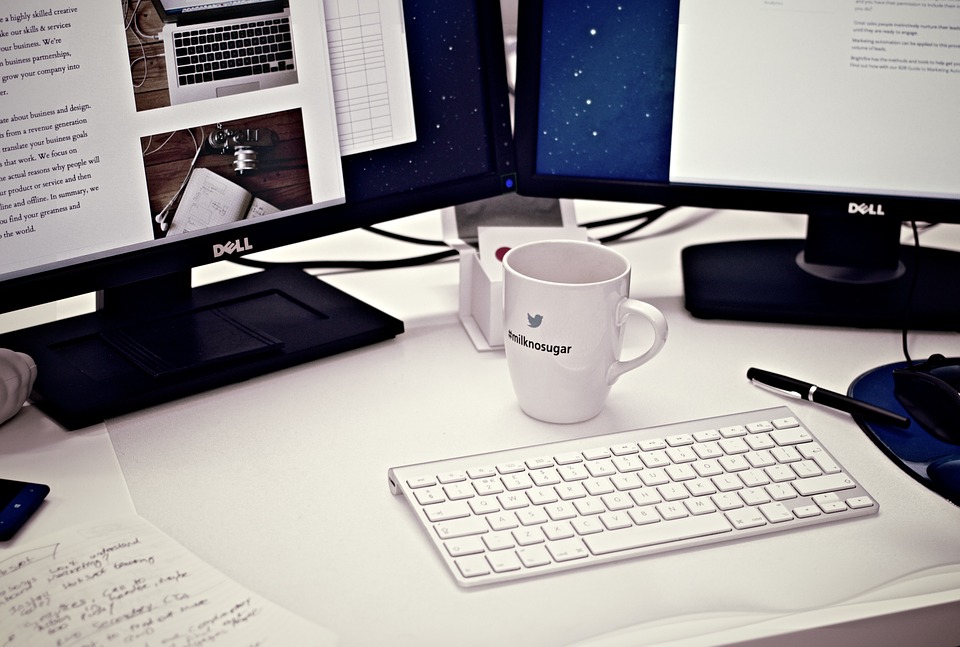 desktop computer and a cup